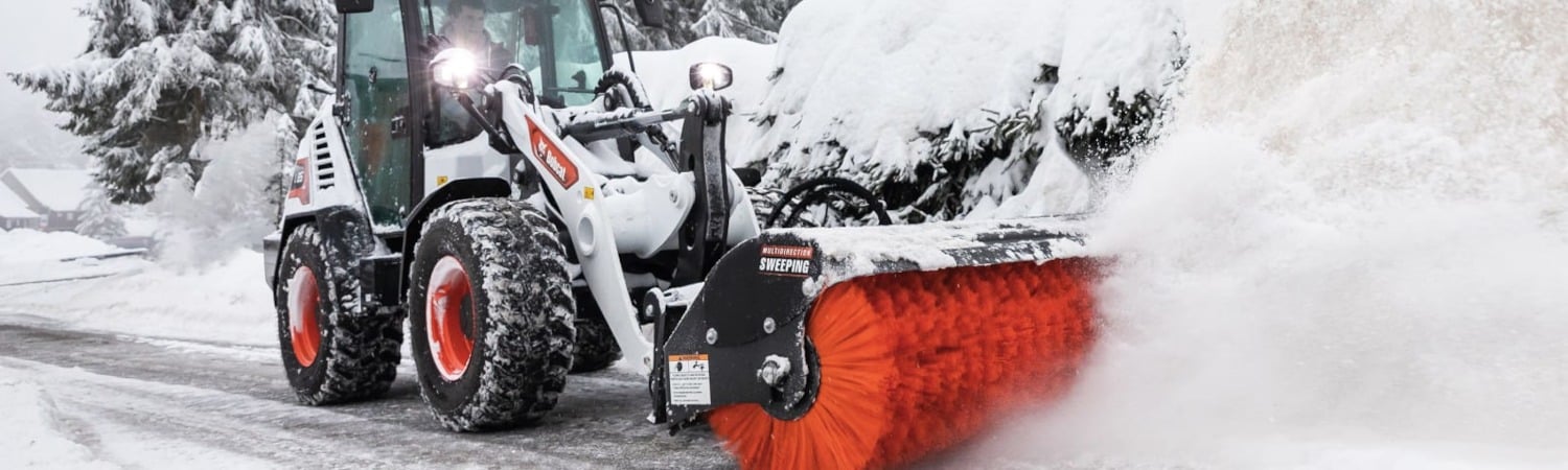 Bobcat loader with sweeping attachment